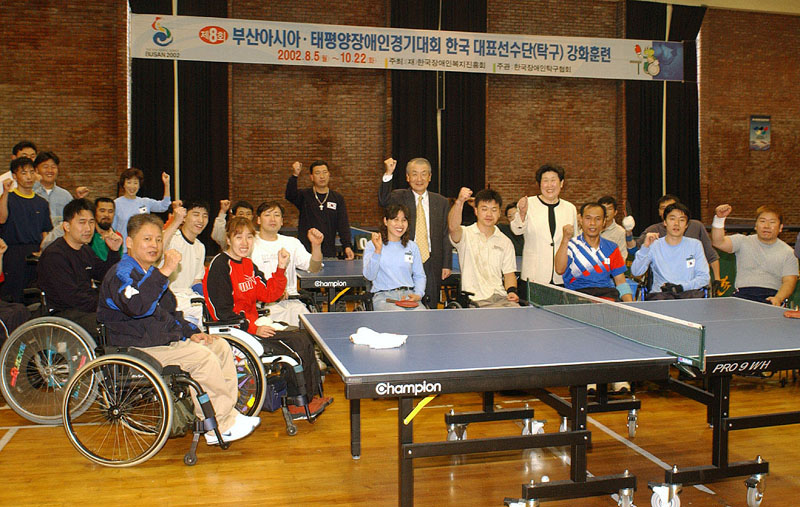 Jung Nam Cho, vice-chairman of SK Telecom, is shown visiting the training center located in Seoul Veterans Hospital at Duenchon-dong and encouraging table tennis players.